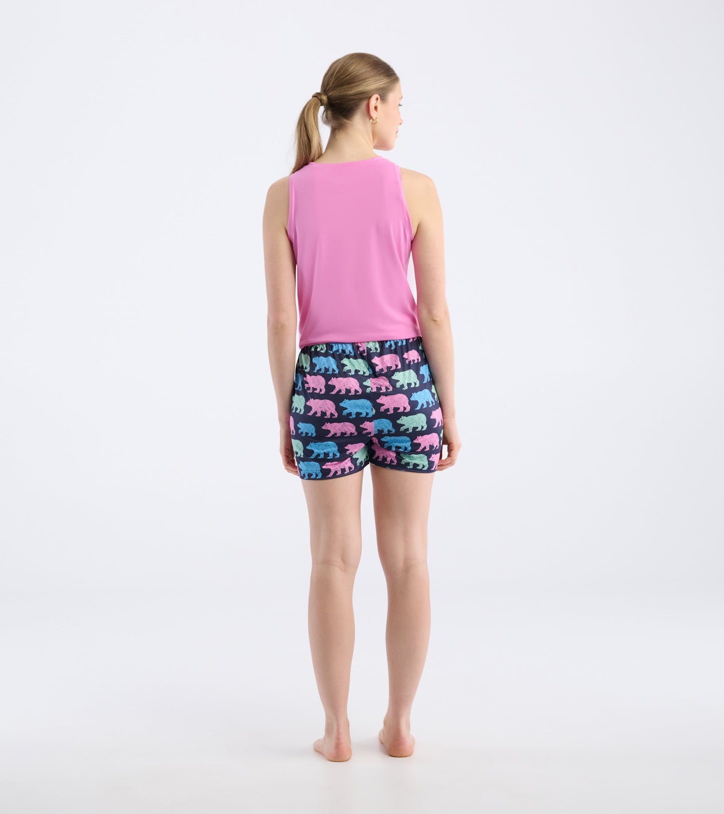 Back view of women's pajama shorts featuring colorful bear patterns on a dark background, made from soft polyknit material.