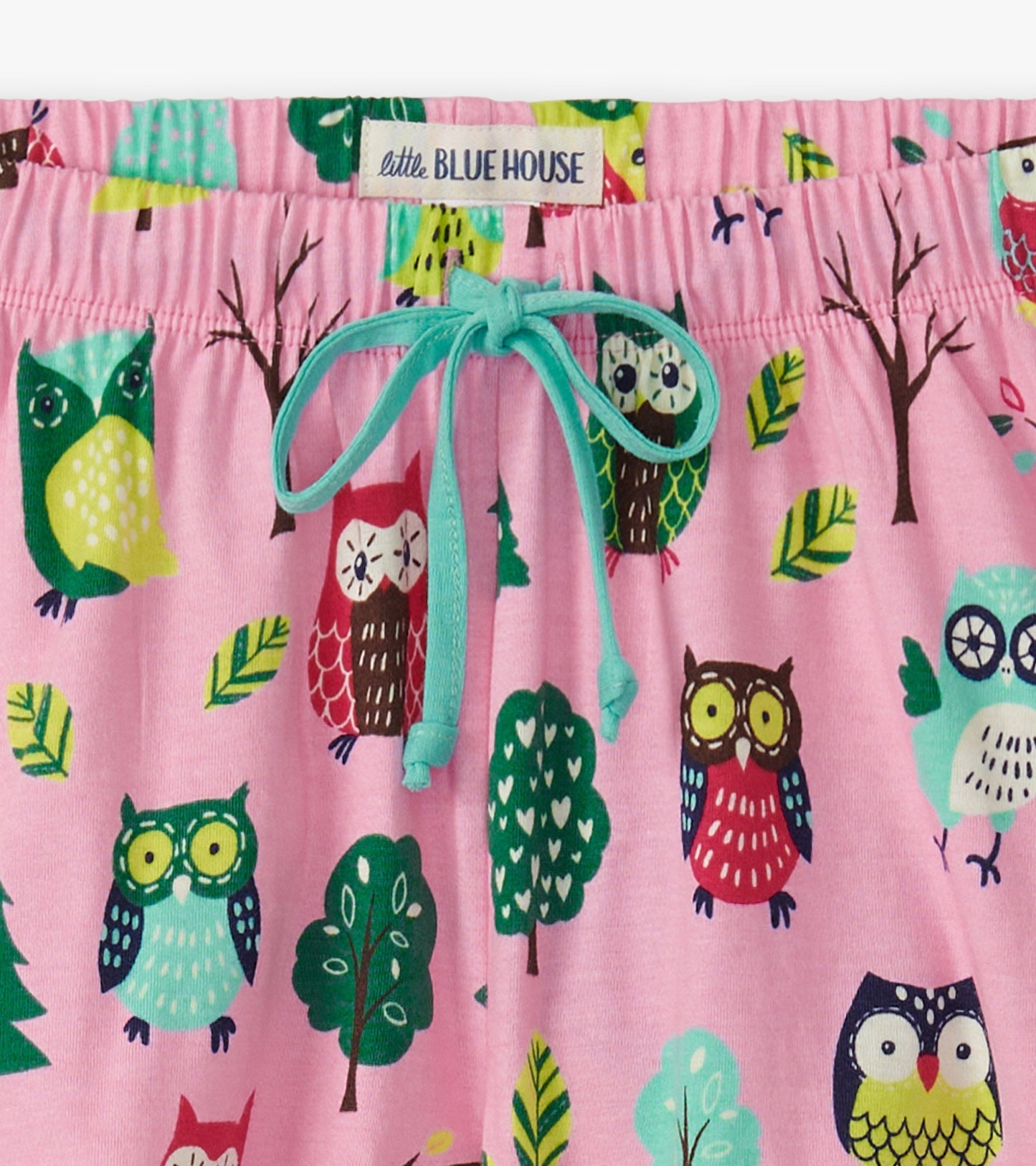 Pink cotton sleep shorts featuring colorful owl and tree patterns, with a drawstring waistband.