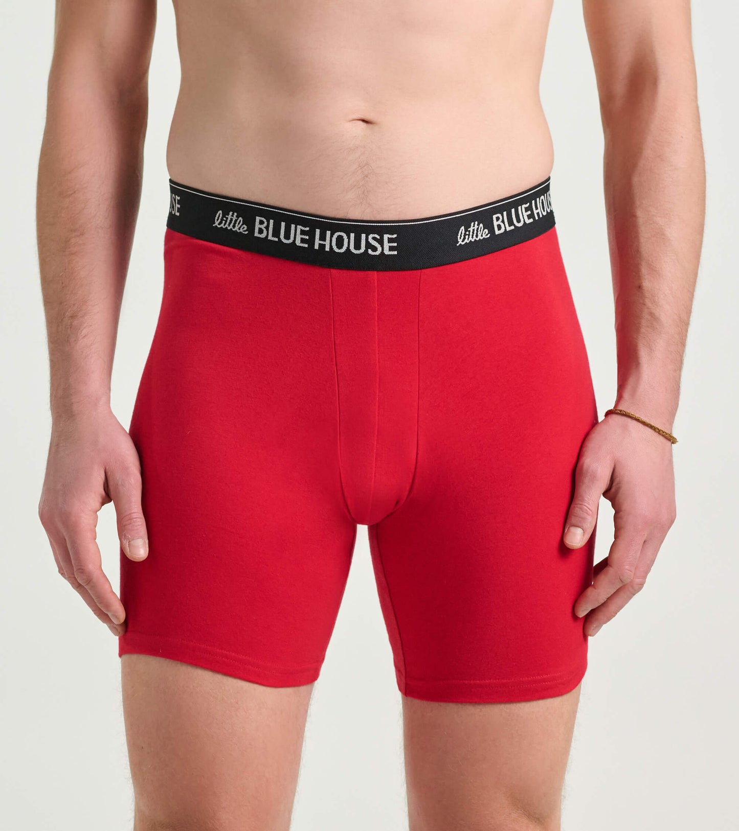Red men's boxer briefs with a black waistband, featuring a snug fit and mid-thigh length.