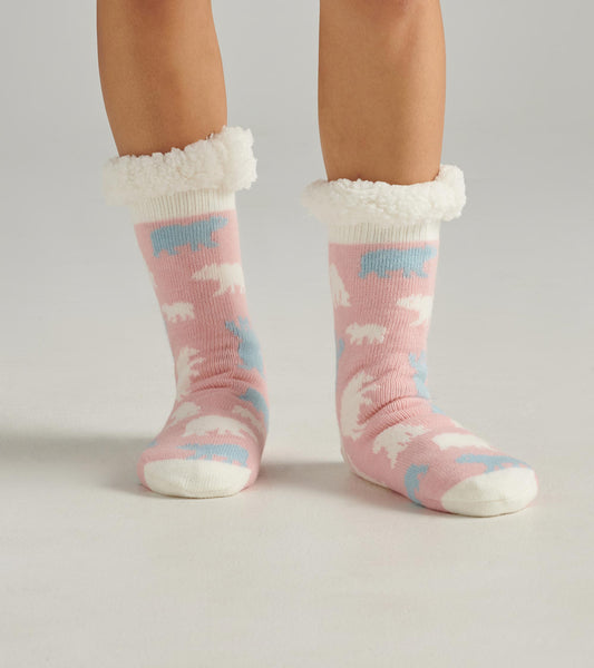 Pink cabin socks with polar bear patterns and a fluffy white cuff, designed for warmth and comfort.