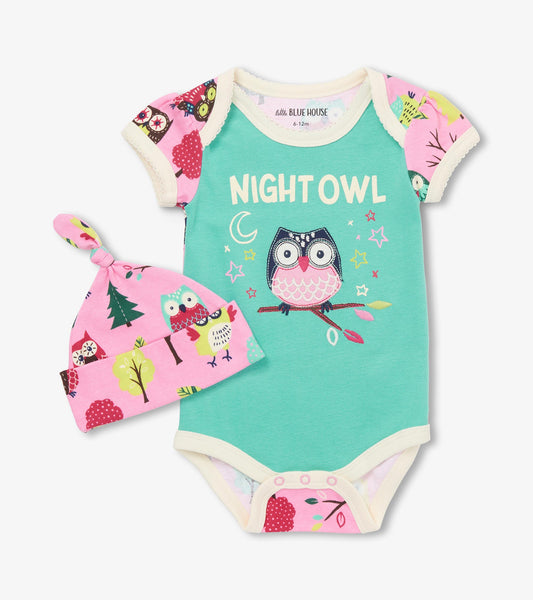Turquoise bodysuit with owl graphic and pink hat featuring colorful forest animals and trees, suitable for infants.