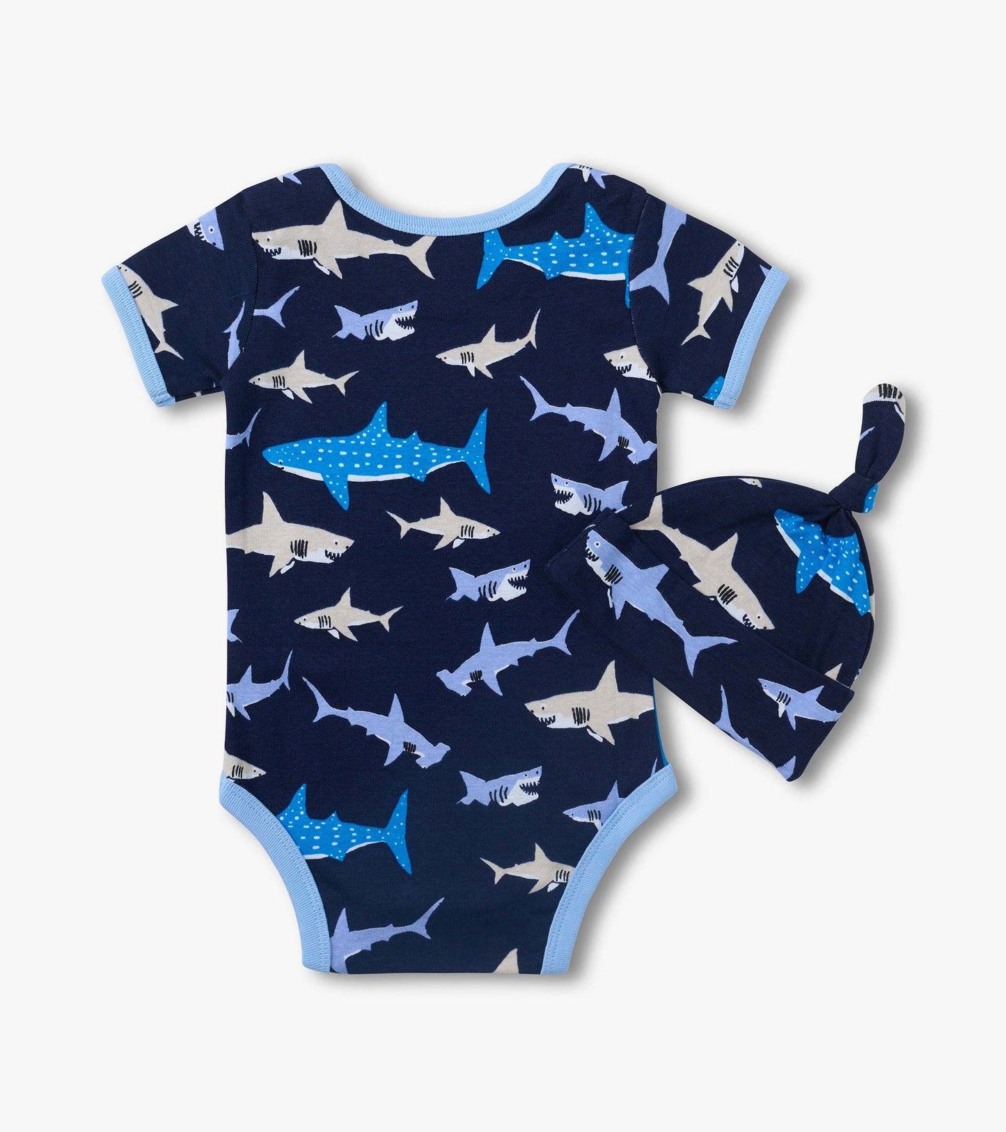 Navy baby bodysuit with shark print and light blue trim, shown with matching shark-print hat.