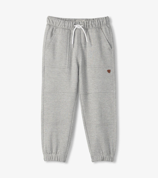 Grey cozy pants with an elastic waistband, drawstring, and side pockets, designed for comfort and casual wear.