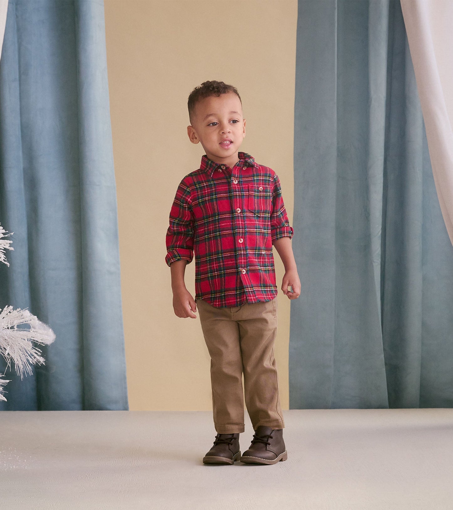 Khaki twill pants for babies, featuring a classic fit and soft material, paired with a plaid shirt and boots.