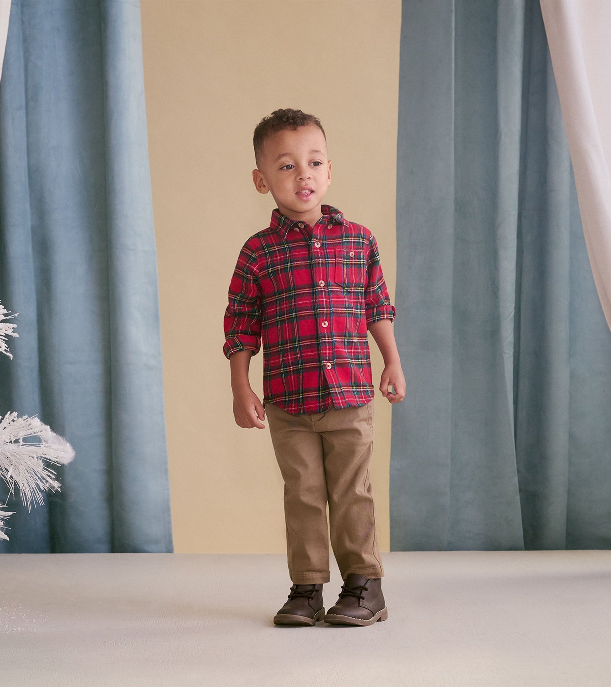 Khaki twill pants for babies, featuring a classic fit and soft material, paired with a plaid shirt and boots.