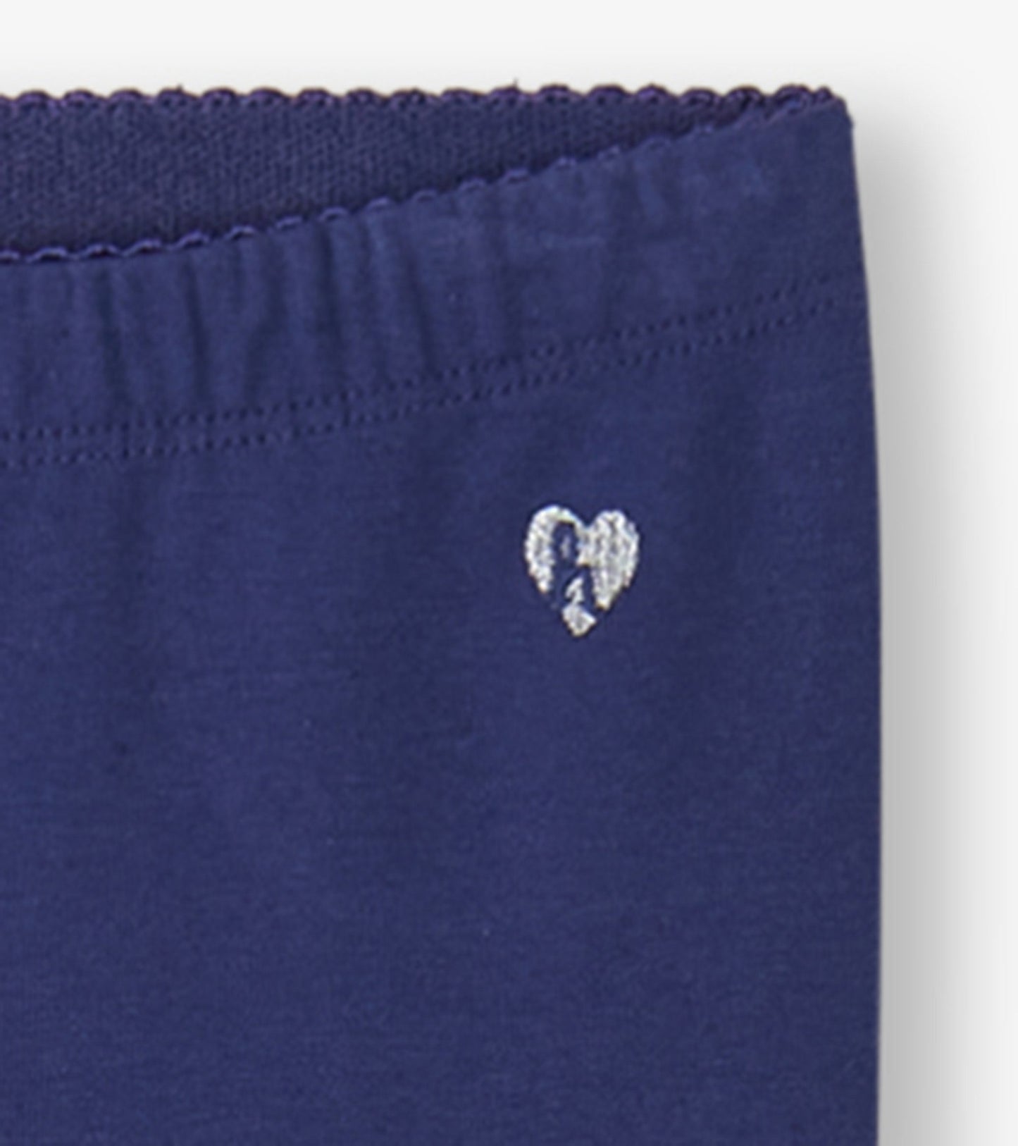Navy leggings featuring a soft elastic waistband and a small heart embroidery detail.