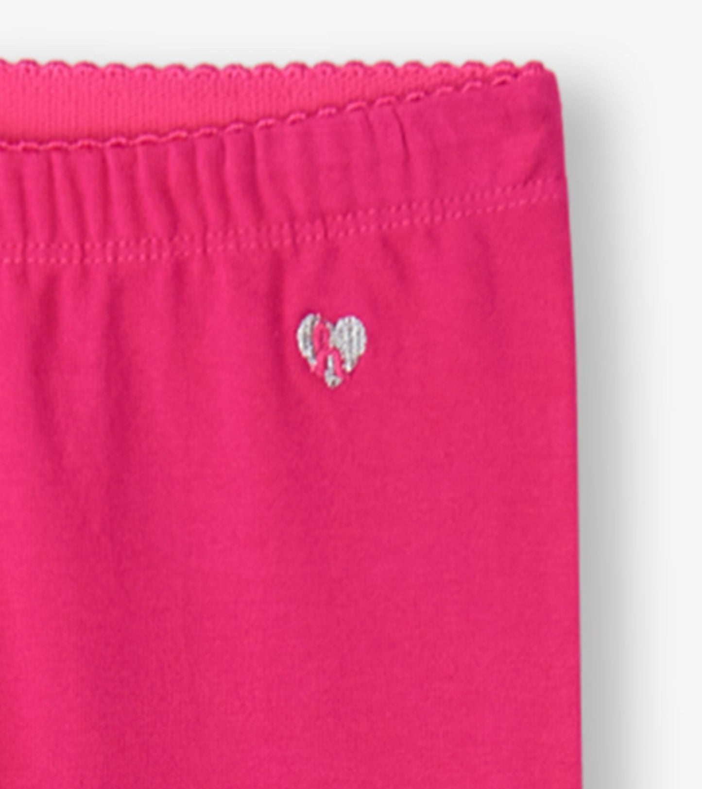 Bright pink leggings with an elastic waistband and a small heart logo detail. Suitable for casual wear.