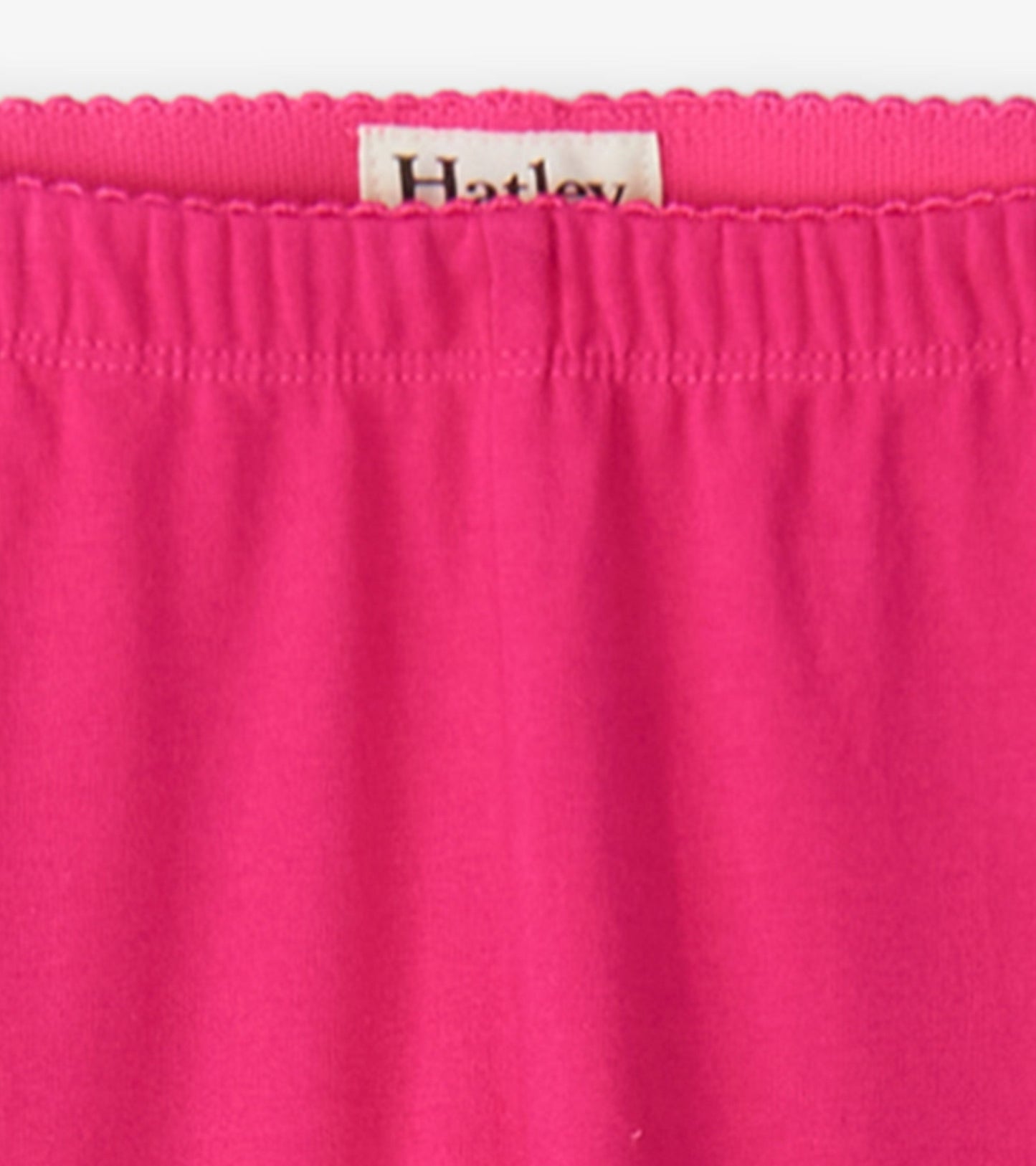 Bright pink leggings with an elastic waistband, made from soft, stretchy material for comfort and ease of movement.