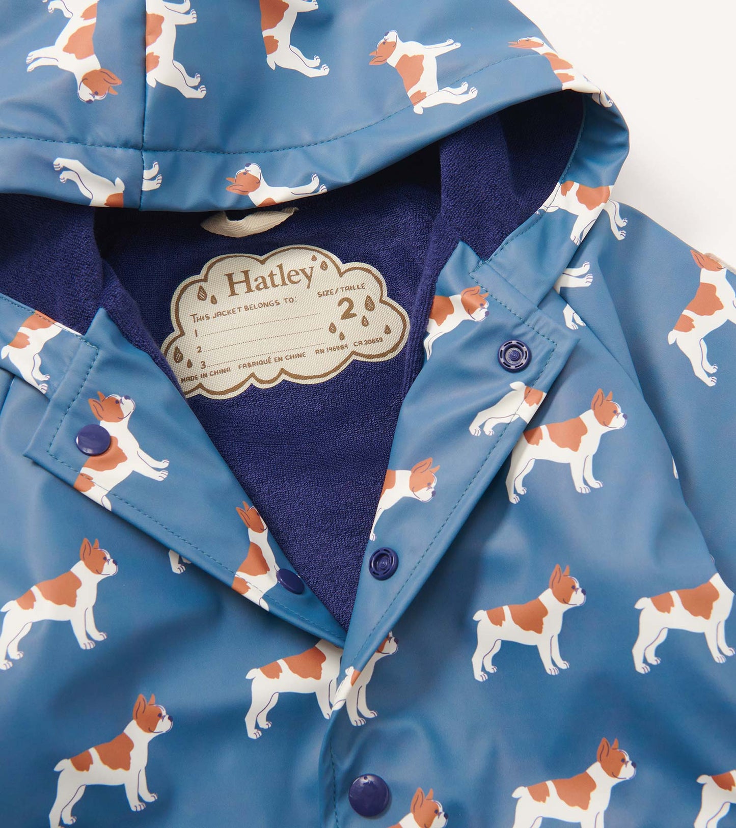 Blue rain jacket featuring a French bulldog pattern, with a hood and button-up front. Soft interior lining visible.