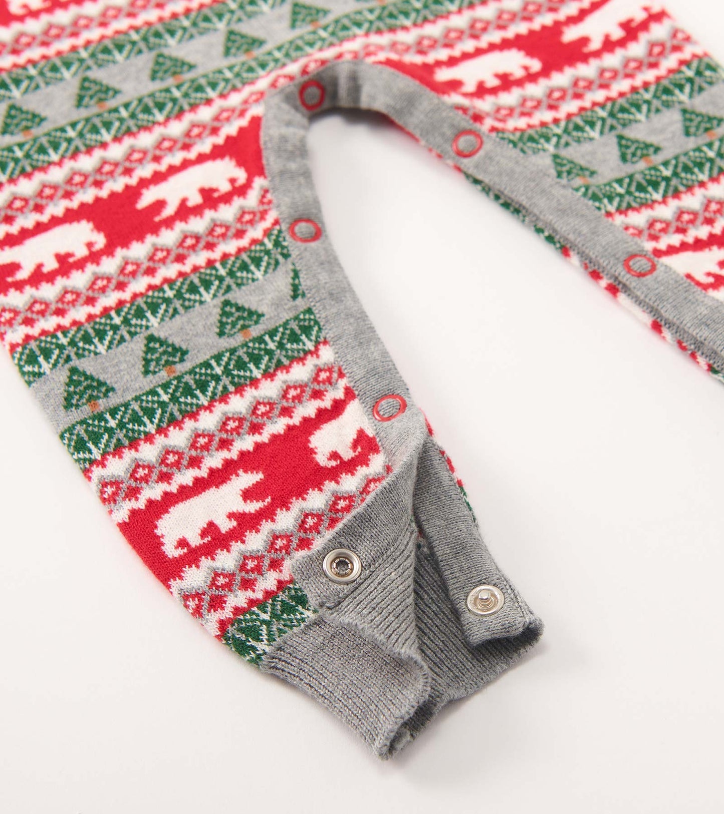 Red, green, and gray Fair Isle sweater romper featuring polar bear and tree patterns, with snap closures at the bottom.