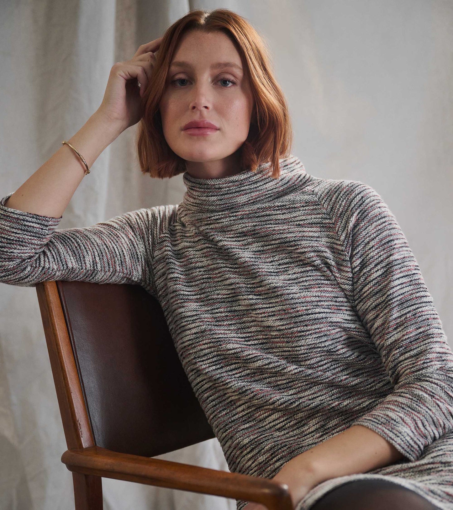 Heather grey ribbed turtleneck dress with long sleeves and a fitted silhouette, worn by a model.