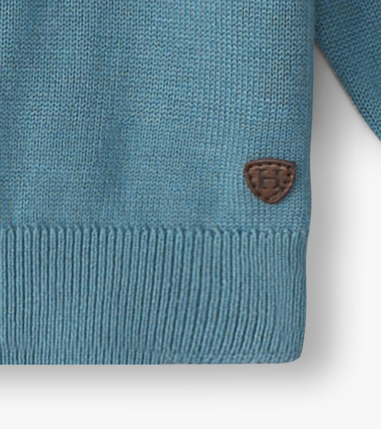 Light blue crew neck sweater for baby and toddler boys, featuring a textured knit and a small brown logo patch.