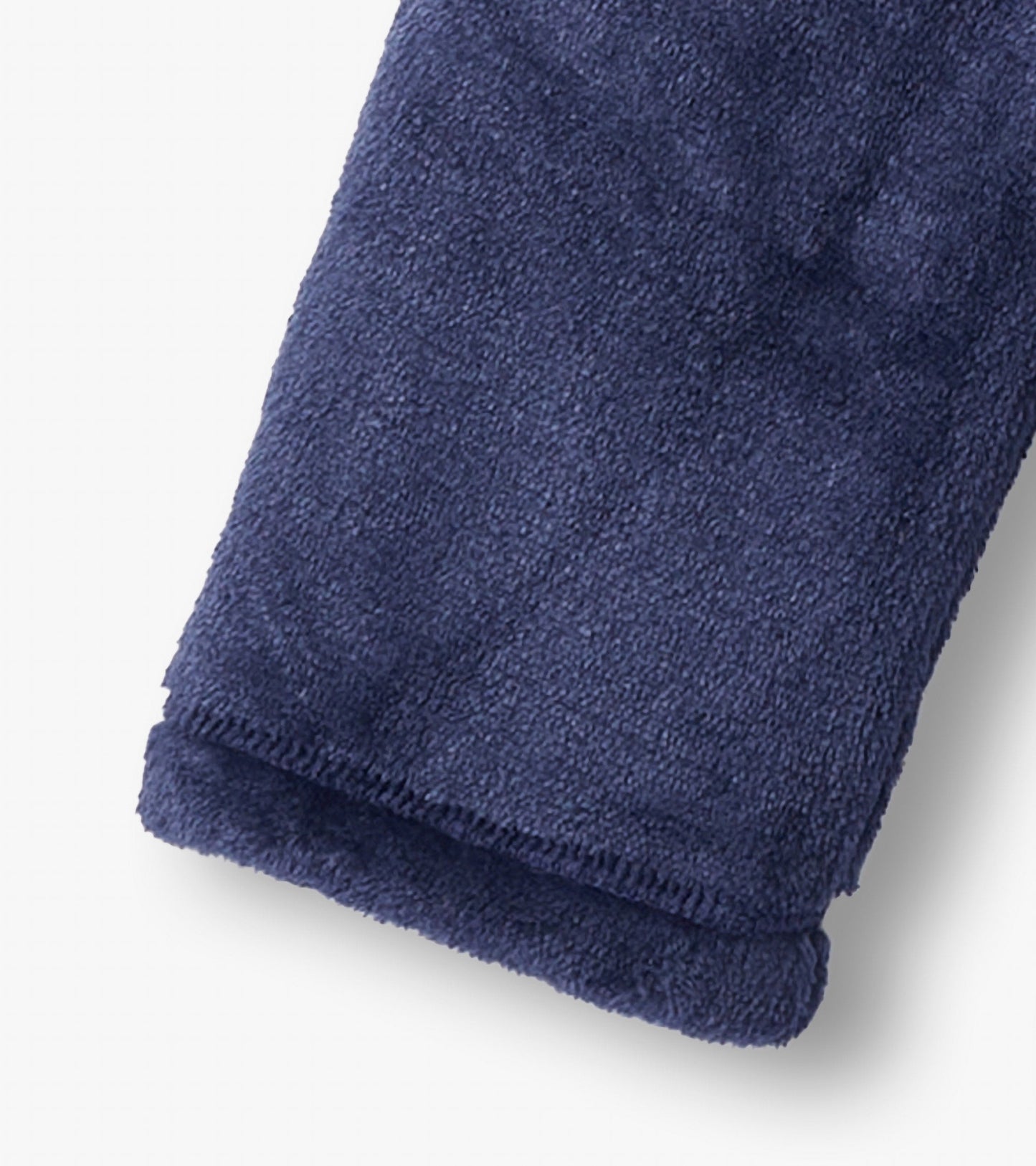 Navy fuzzy fleece fabric with a soft texture, showcasing the cuff of a zip-up jacket.