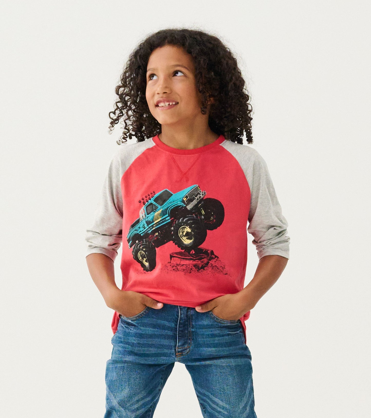 Red long sleeve raglan t-shirt with gray sleeves featuring a graphic of a blue monster truck.