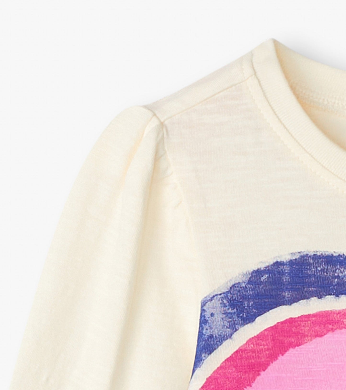 Cream long sleeve tee featuring a layered heart graphic in pink and blue, with a round neckline and soft fabric.
