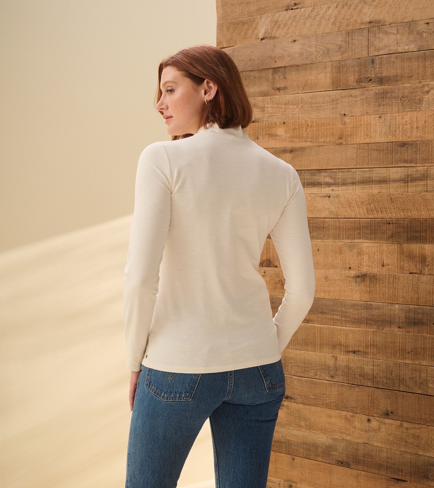 Back view of cream white mock neck top with long sleeves
