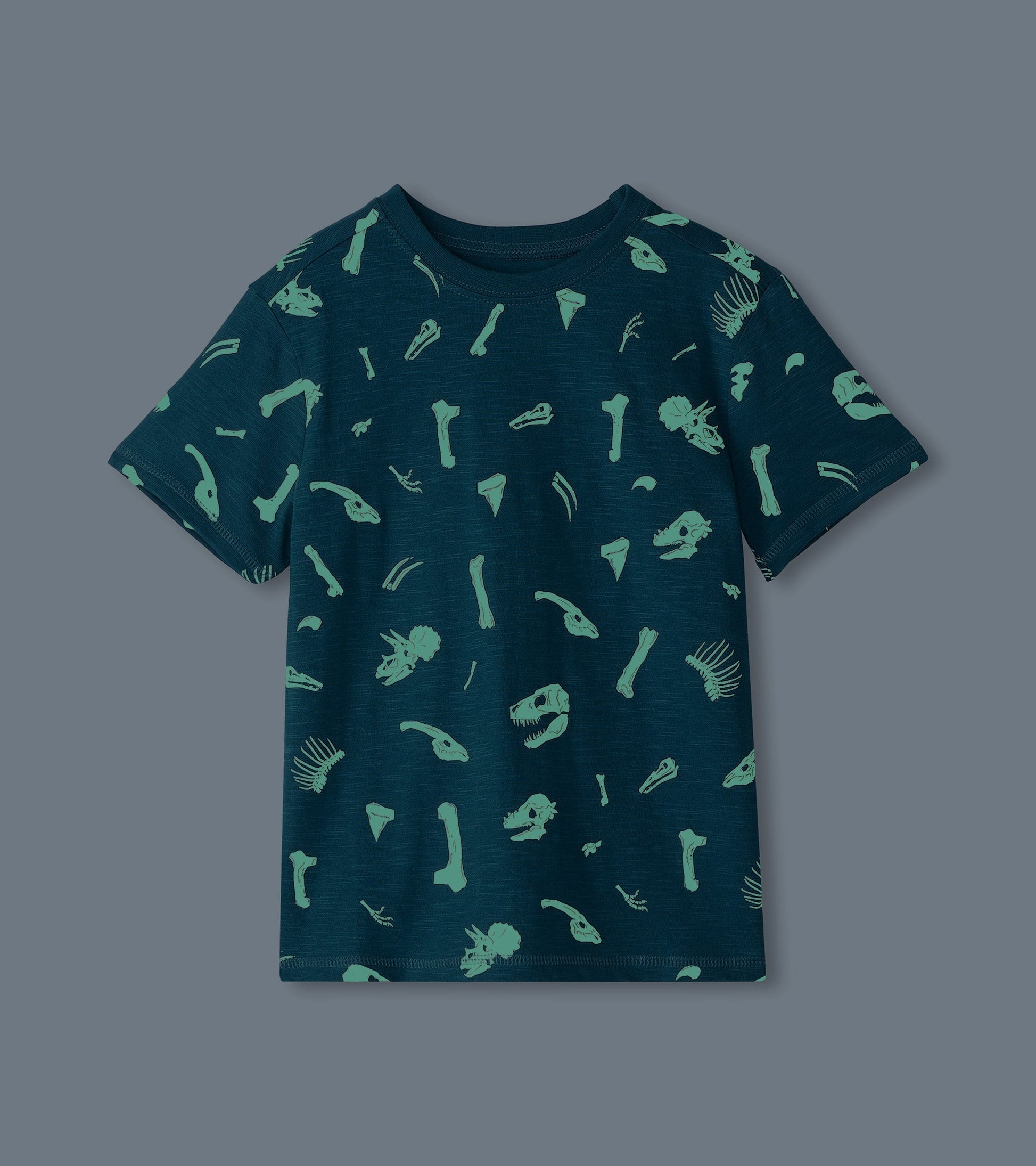Dark teal graphic tee featuring glow-in-the-dark dinosaur fossil prints, short sleeves, and a crew neckline.