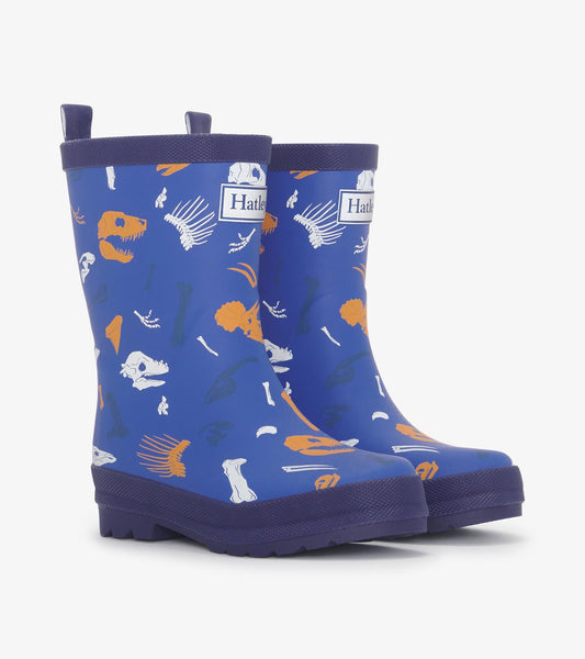 Matte blue rain boots featuring colorful dinosaur fossil patterns, ideal for kids.