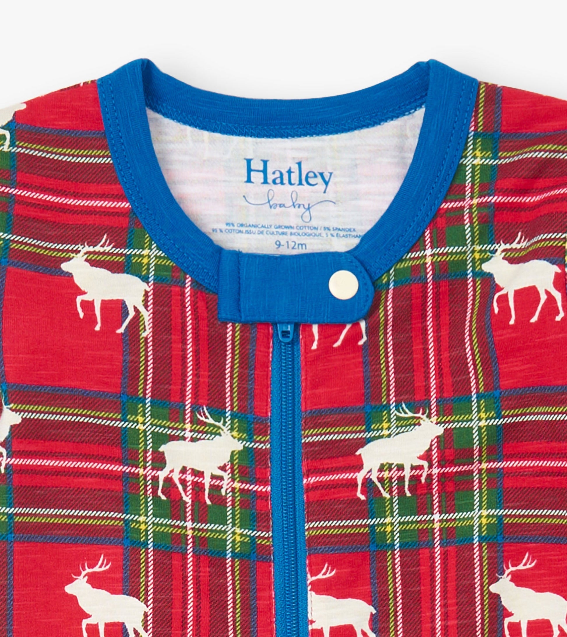 Red plaid footed sleeper with white elk print, featuring a blue neckline and zipper closure, suitable for infants.