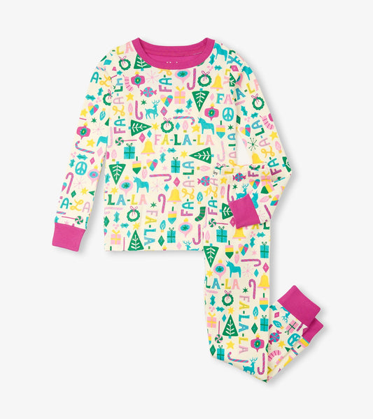 Girls' pink pajama set featuring colorful holiday-themed patterns on a cream background with pink cuffs.