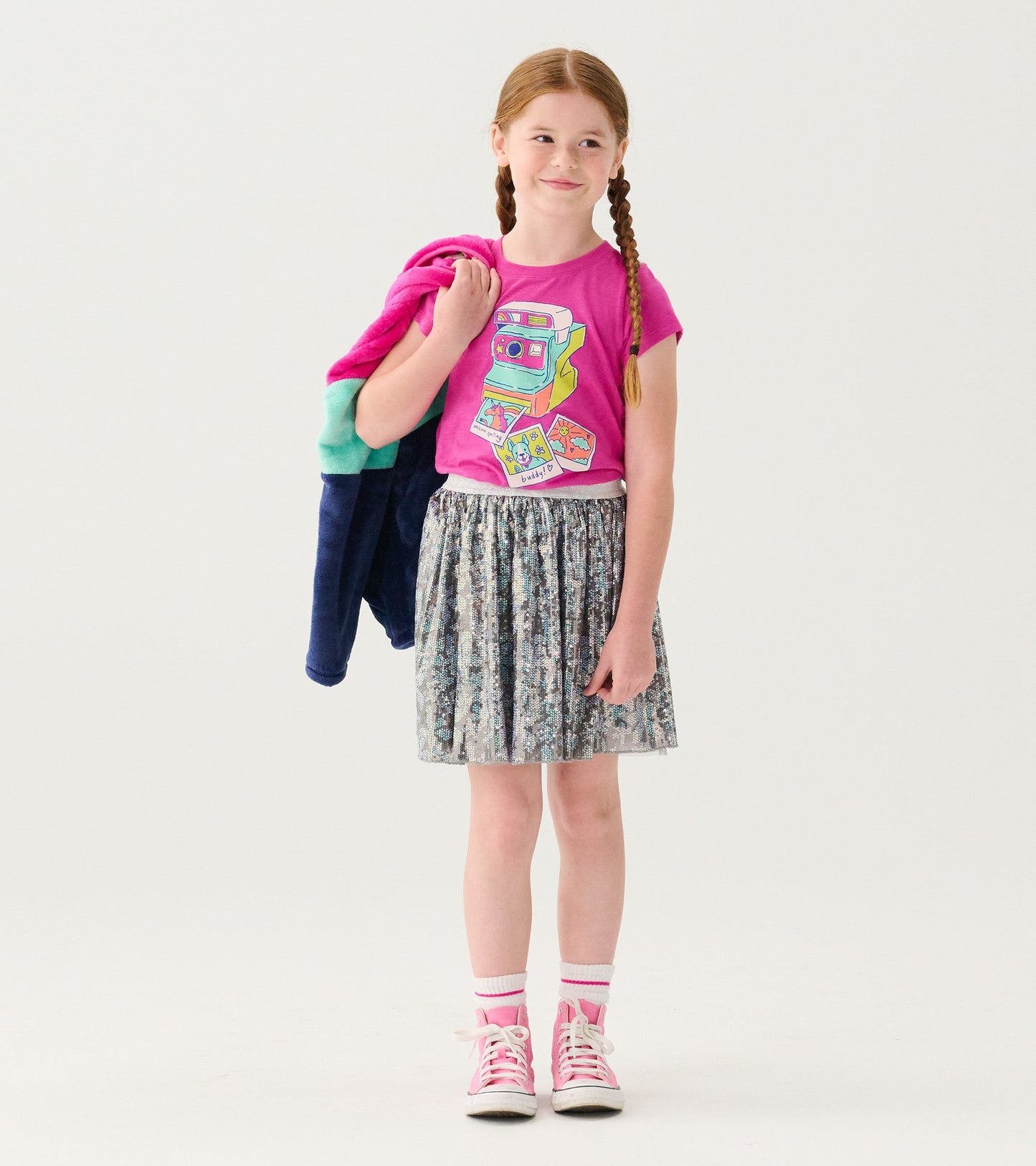 Shimmery tulle skirt with floral sequins, paired with a colorful graphic tee and pink sneakers.