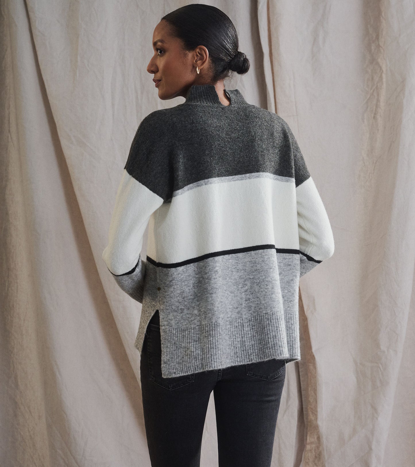 Grey block mock neck tunic with side slits, featuring a mix of dark grey, light grey, and white stripes.