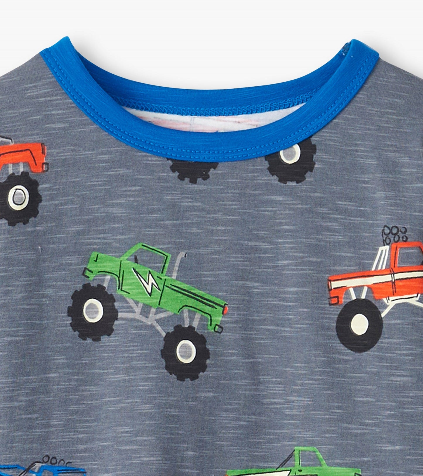Gray pajama top featuring colorful monster truck graphics and a blue crew neckline.