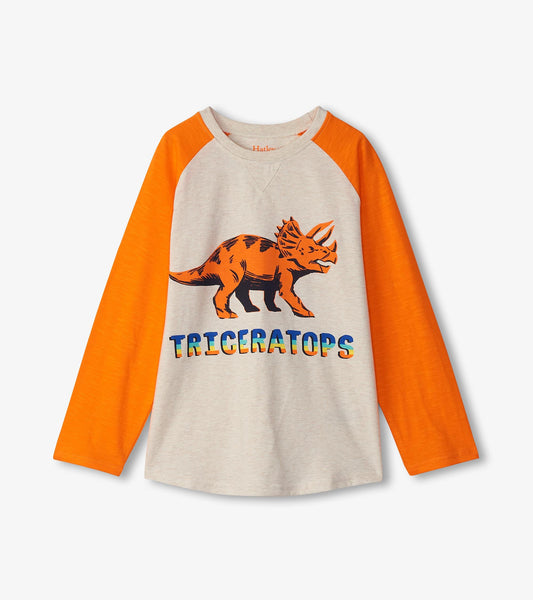 Long sleeve t-shirt featuring a triceratops graphic in orange and gray, with colorful text below.