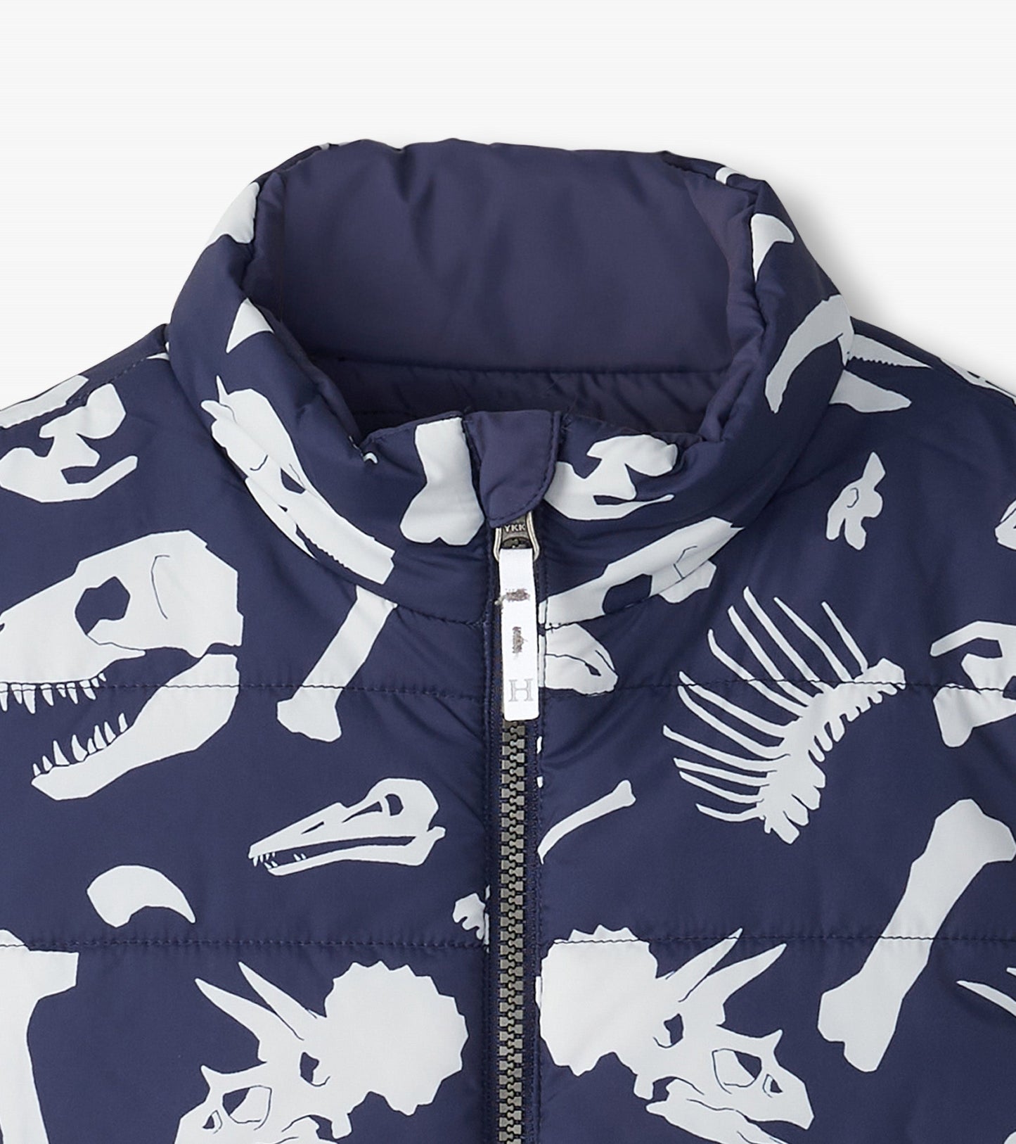 Navy quilted vest featuring white dinosaur fossil prints and a high collar, designed for boys.