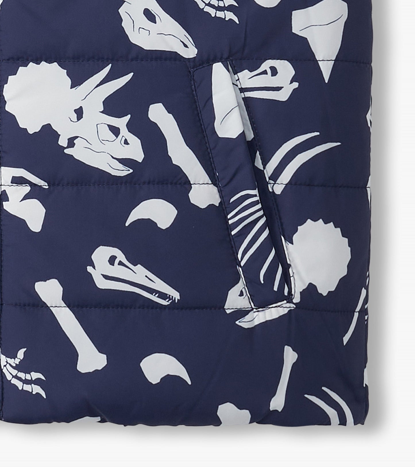 Navy quilted vest featuring white dinosaur fossils and bones, with side pockets for added functionality.