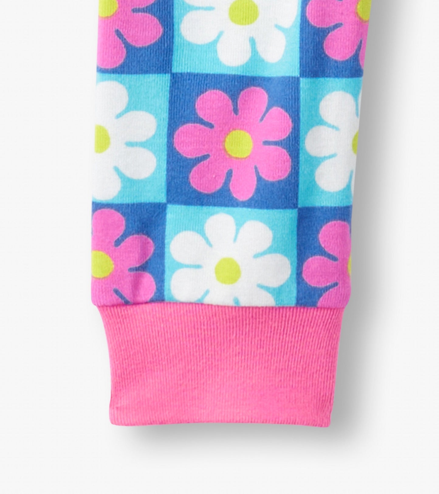 Colorful checkered pajama set featuring pink and white daisies on a blue background, with a pink cuff.