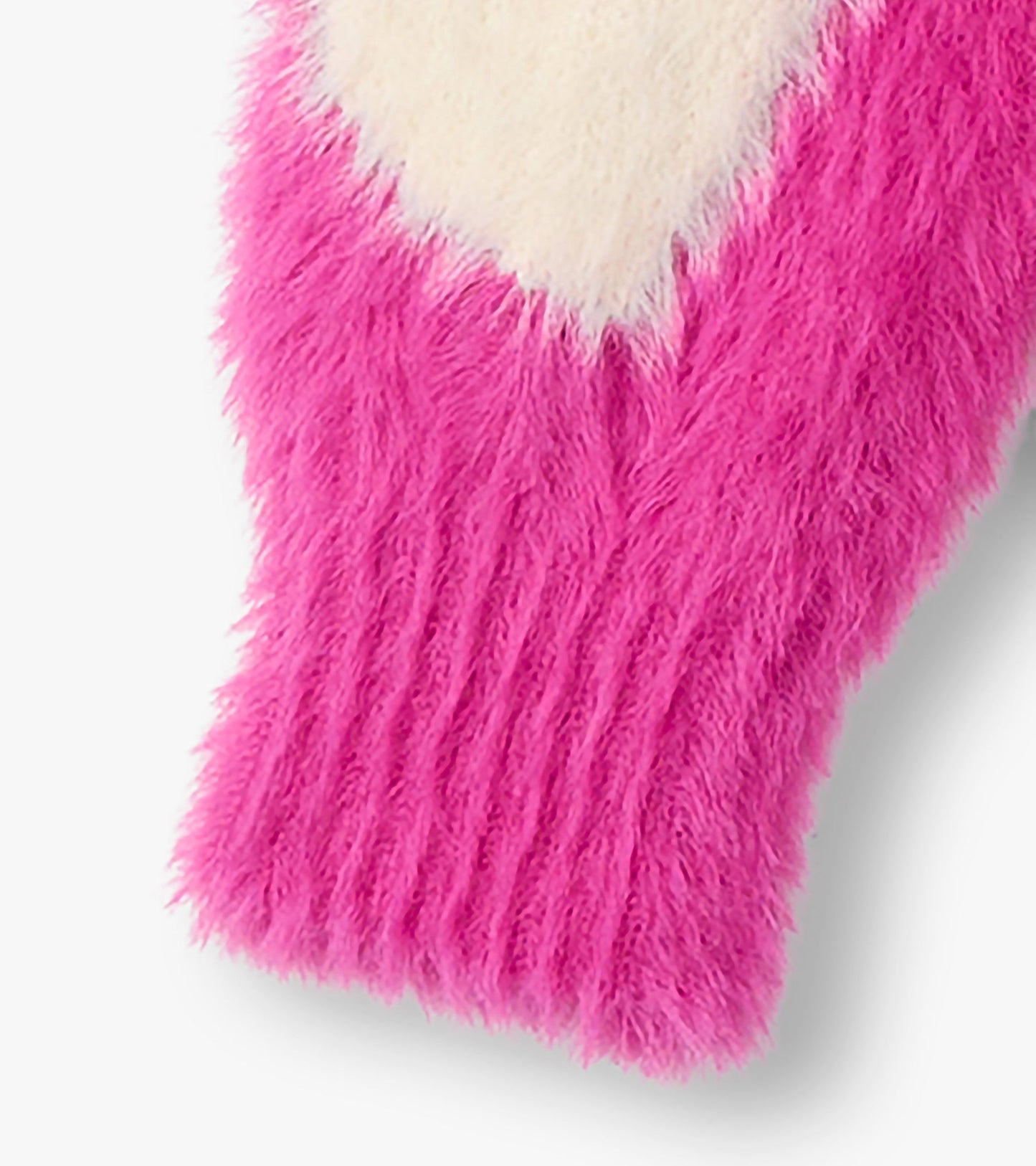 Fuzzy pink cardigan featuring a large white heart pattern, ideal for layering in cooler weather.