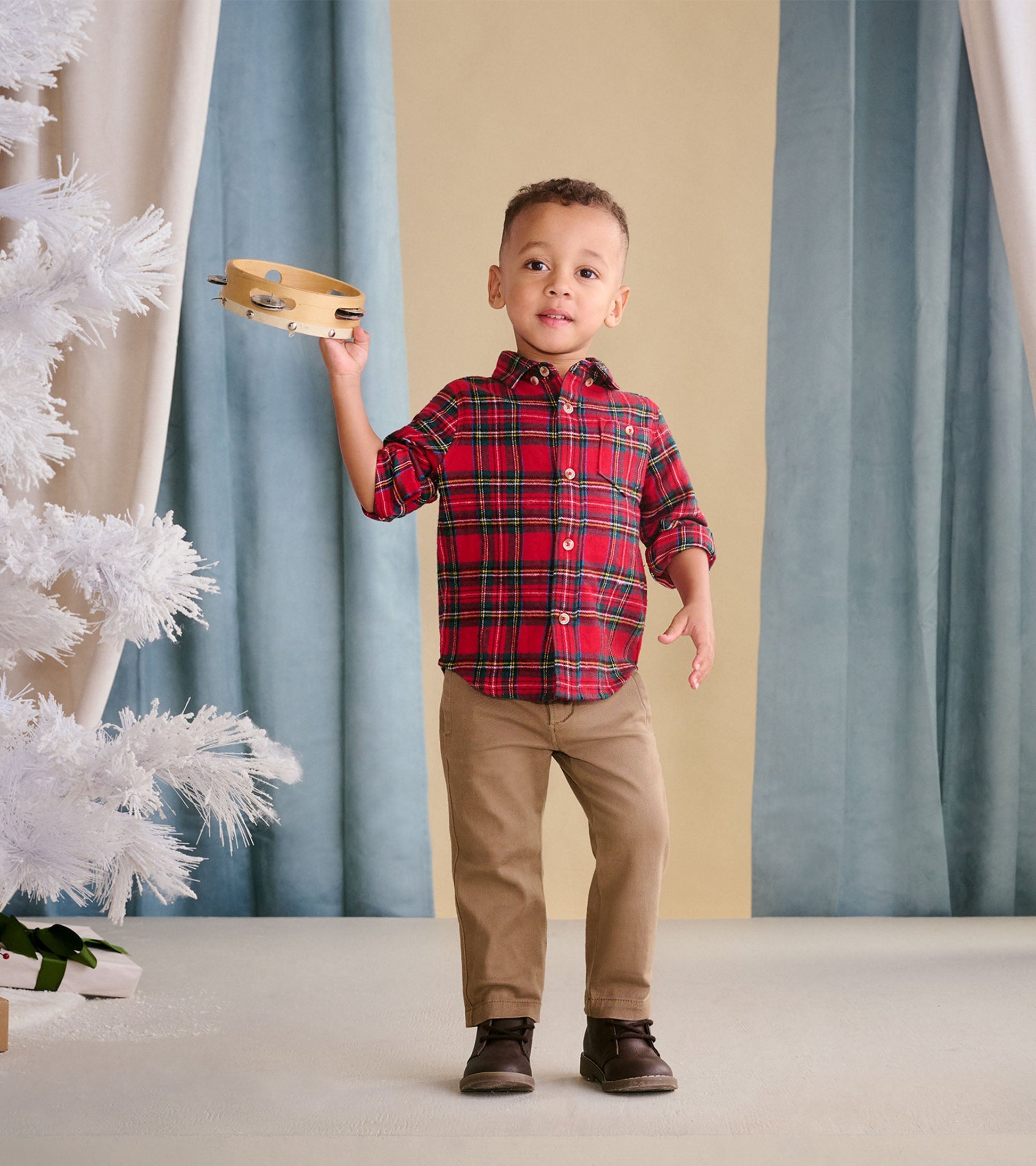 Red plaid button-down shirt for toddlers, featuring a collar and button closure, worn with khaki pants.