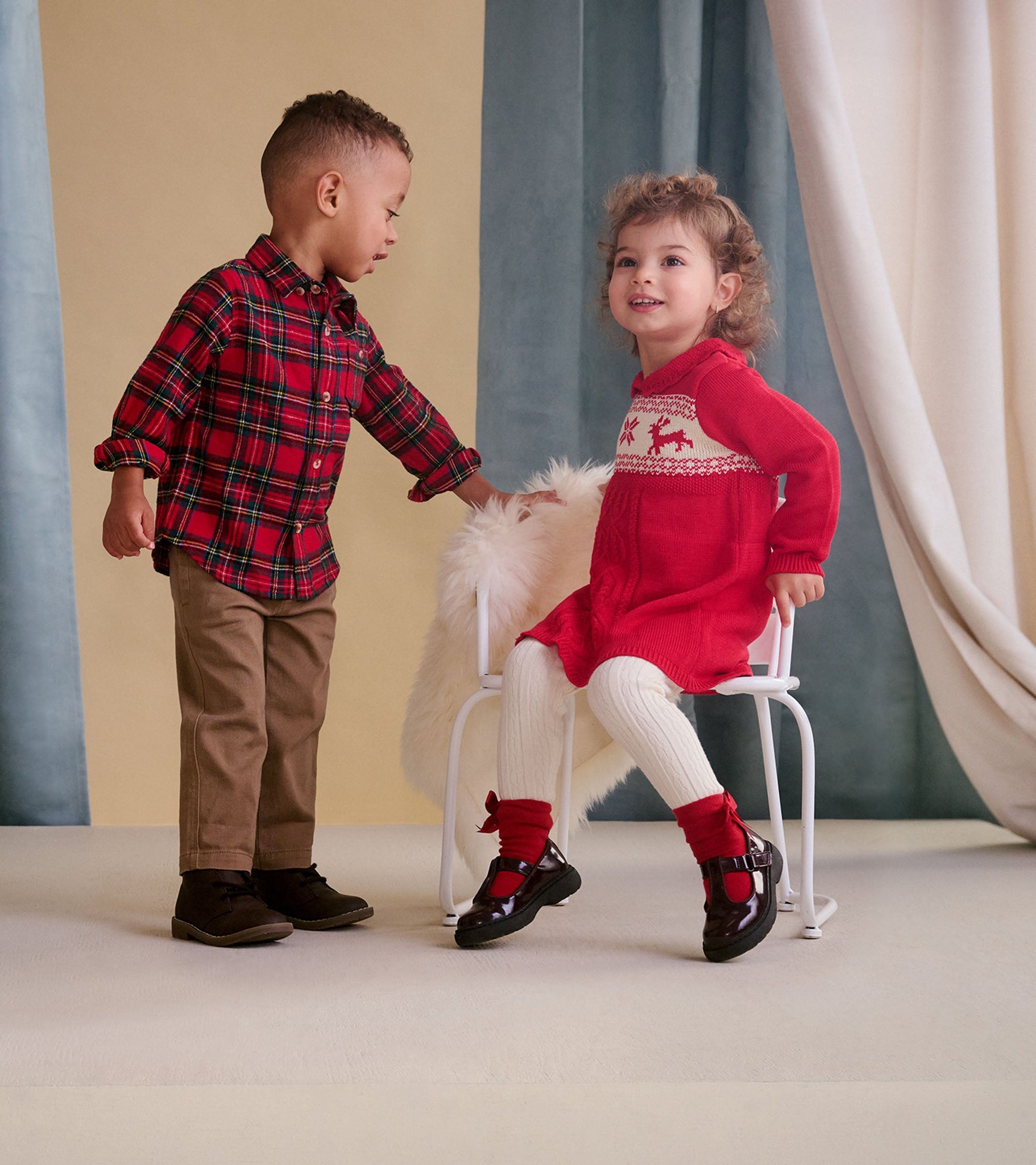 Red plaid button-down shirt for toddlers, featuring a classic collar and button closure, styled with khaki pants.
