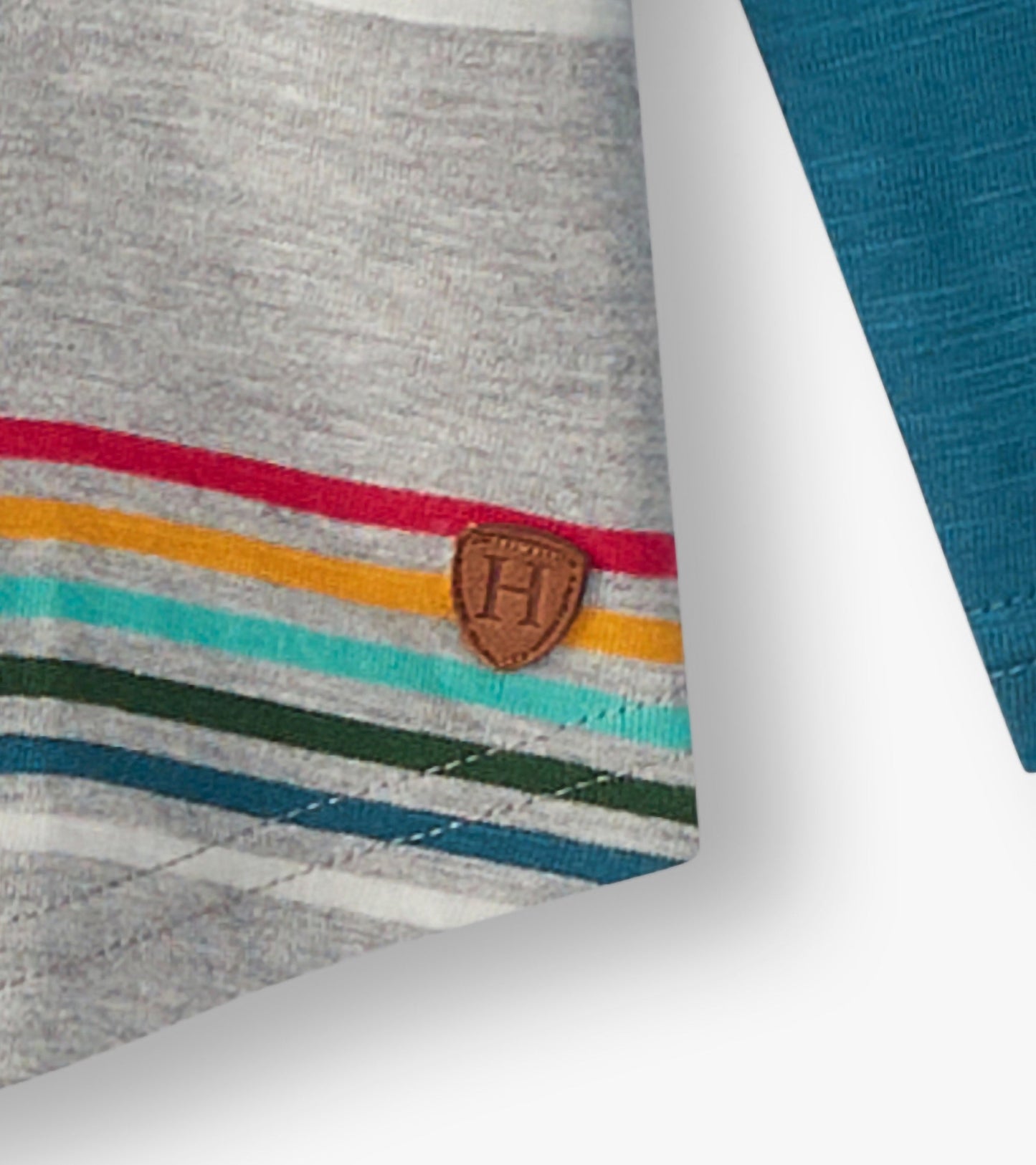Gray long sleeve raglan t-shirt featuring colorful retro stripes and a small logo patch near the hem.