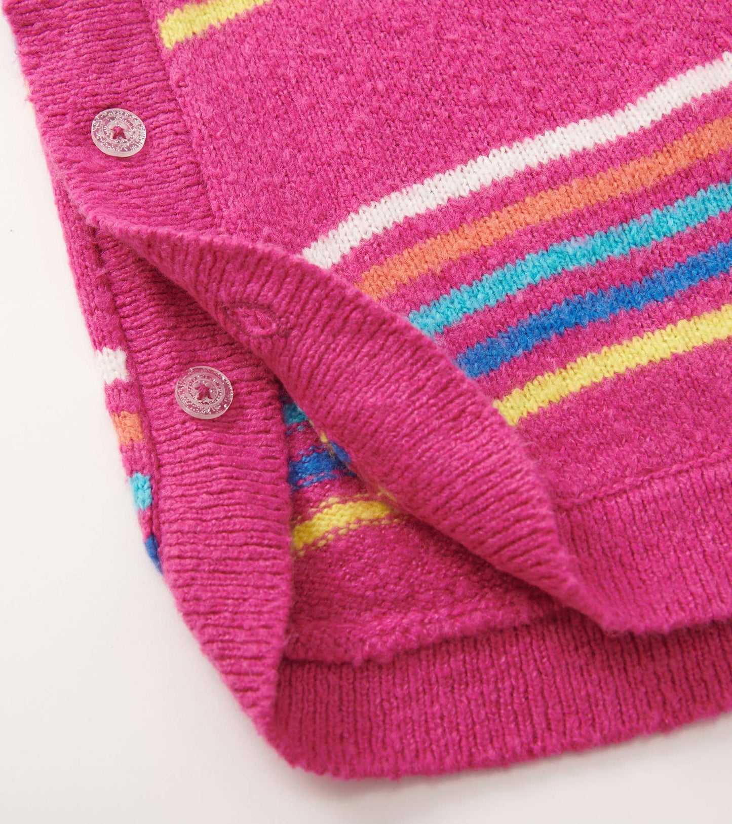 Pink sweater tunic featuring rainbow stripes and button detail, perfect for layering in cooler weather.