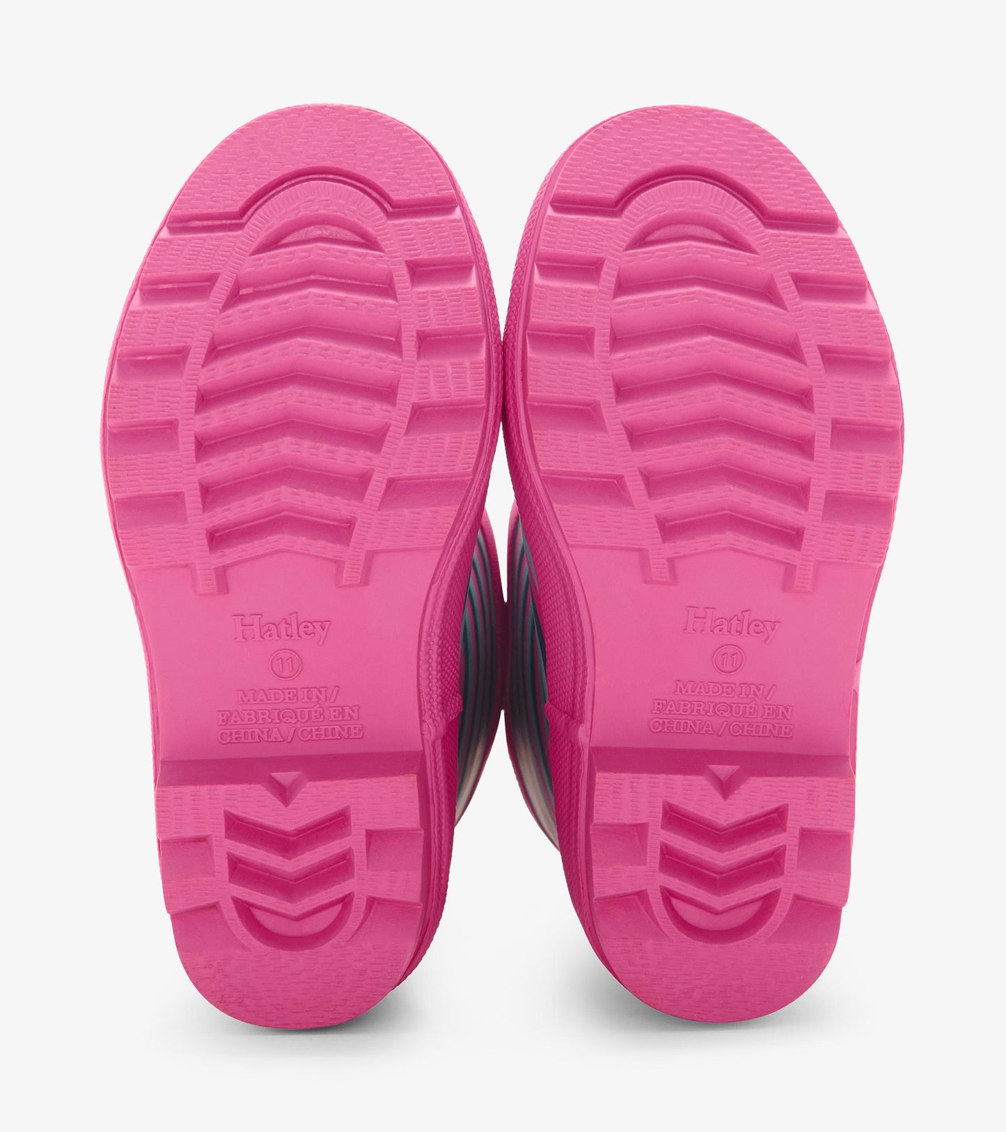 Pink rubber rain boot soles with textured grip and violet stripes, designed for kids.