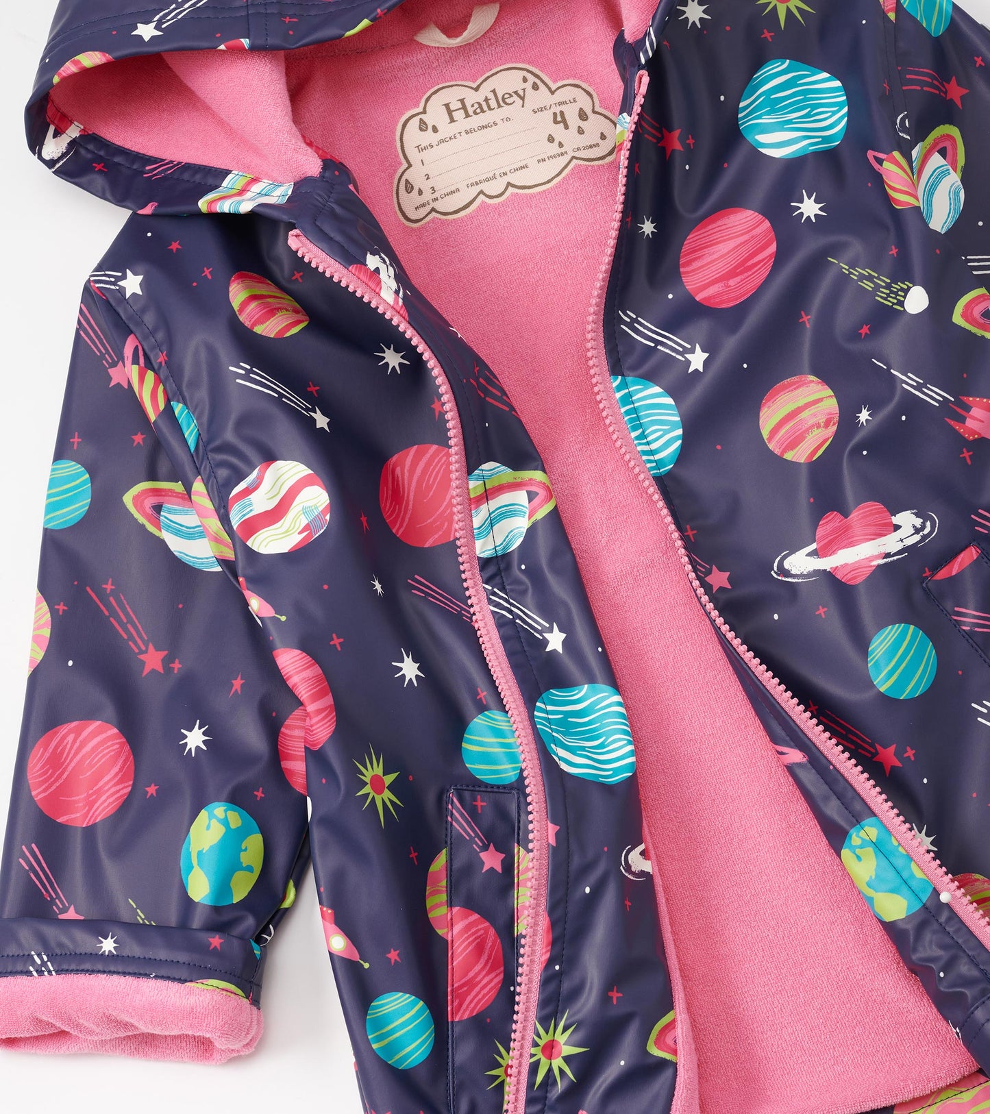 Navy zip-up rain jacket with colorful planet and star print, featuring a pink fleece lining and hood.