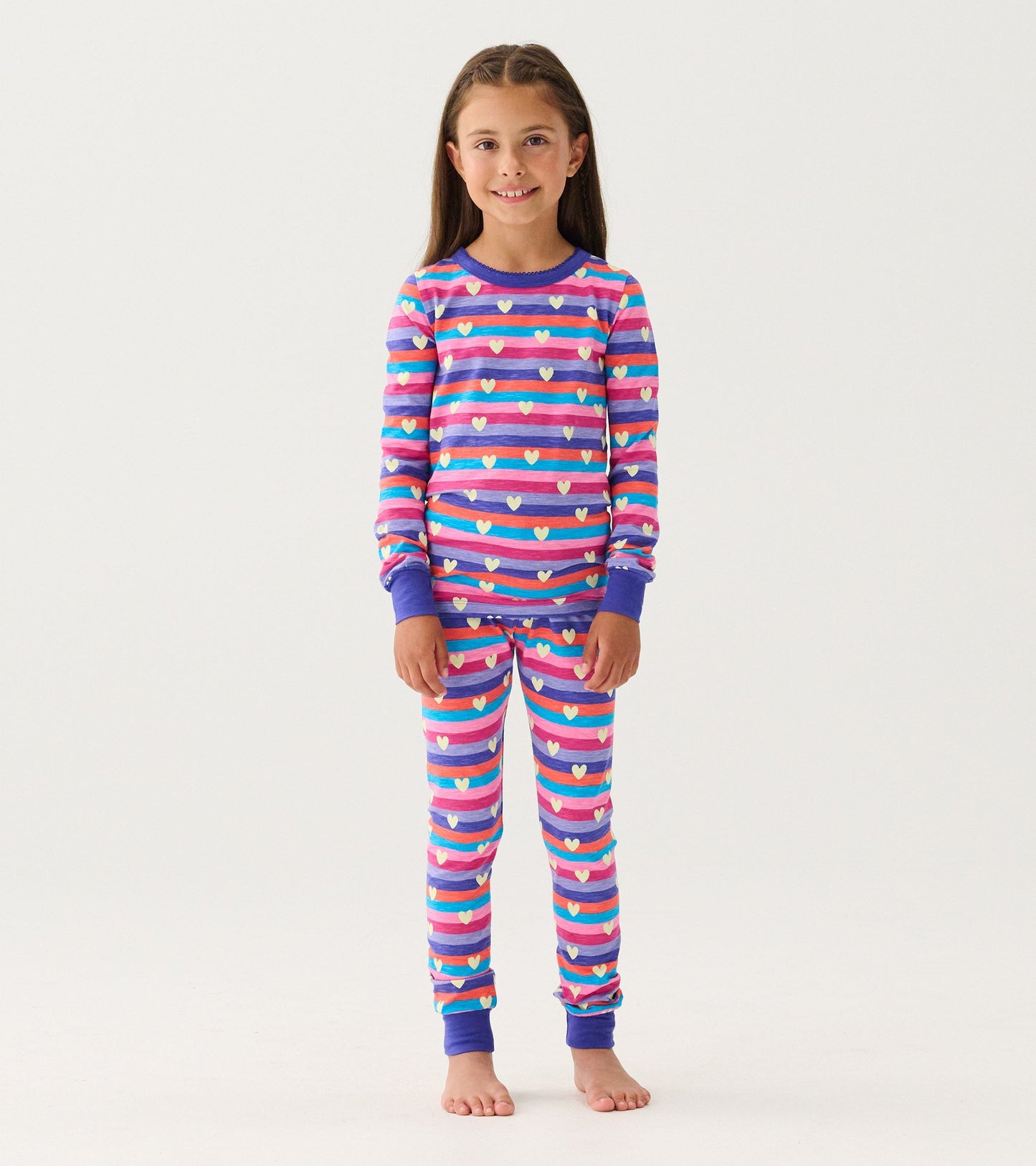 Purple striped pajama set featuring colorful hearts, long sleeves, and matching pants, suitable for girls.