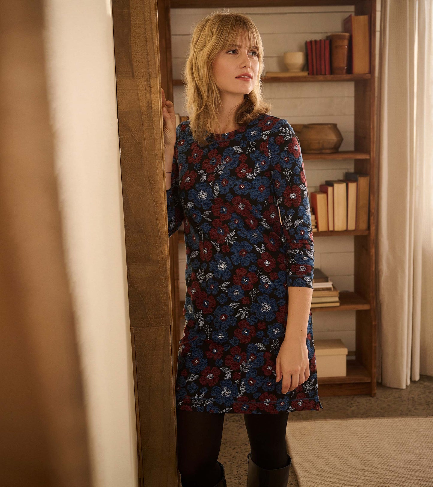 Textured floral dress featuring a dark background with blue and red flowers, perfect for casual wear.