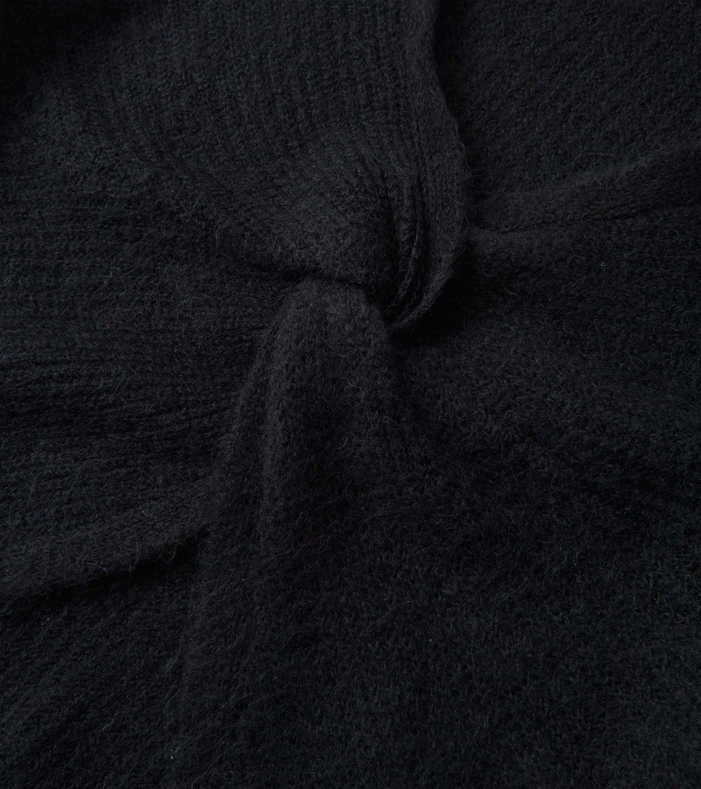 Black cross over sweater with a textured knit pattern, showcasing a soft and cozy fabric.