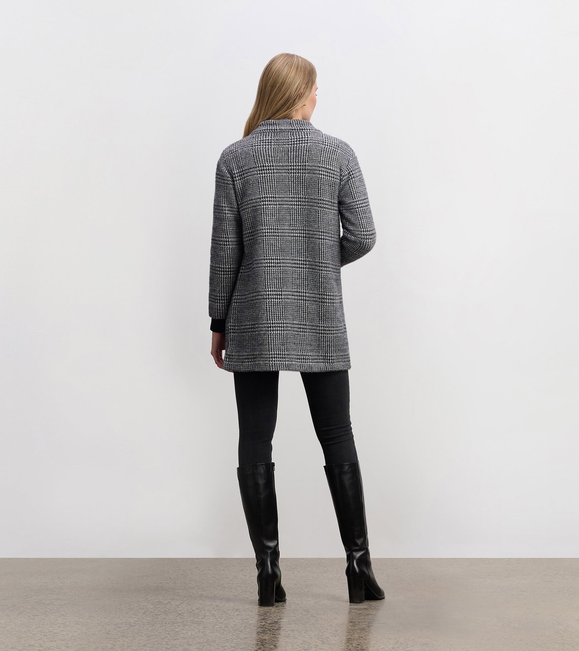 Black check open blazer with a relaxed fit, featuring long sleeves and a collar, viewed from the back.