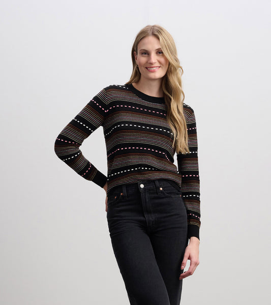 Black sweater featuring colorful horizontal stripes, long sleeves, and a round neckline, styled with black jeans.