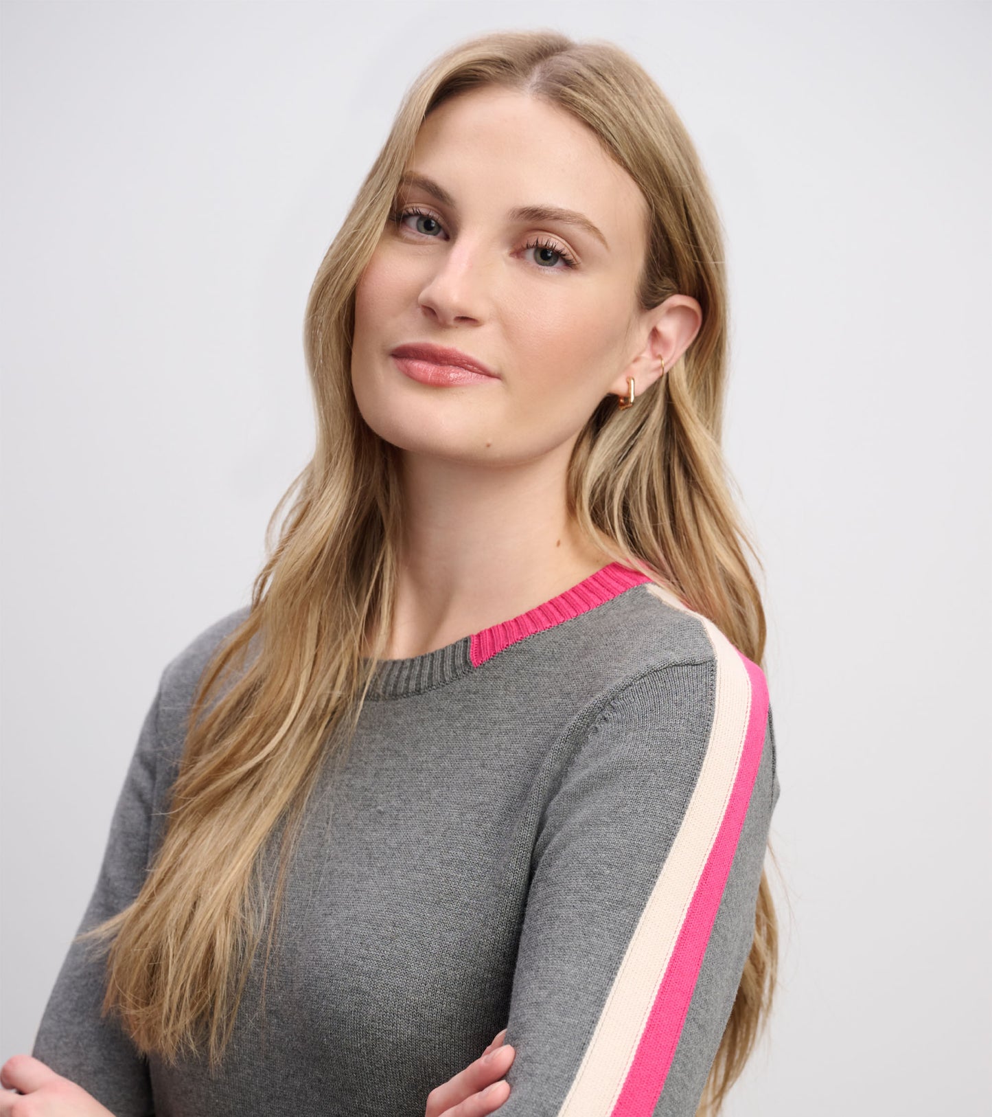 Charcoal sweater dress with contrast pink and cream trim, featuring a round neckline and fitted silhouette.