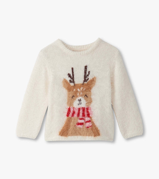 Cream-colored furry sweater featuring a reindeer design with antlers and a red-striped scarf.