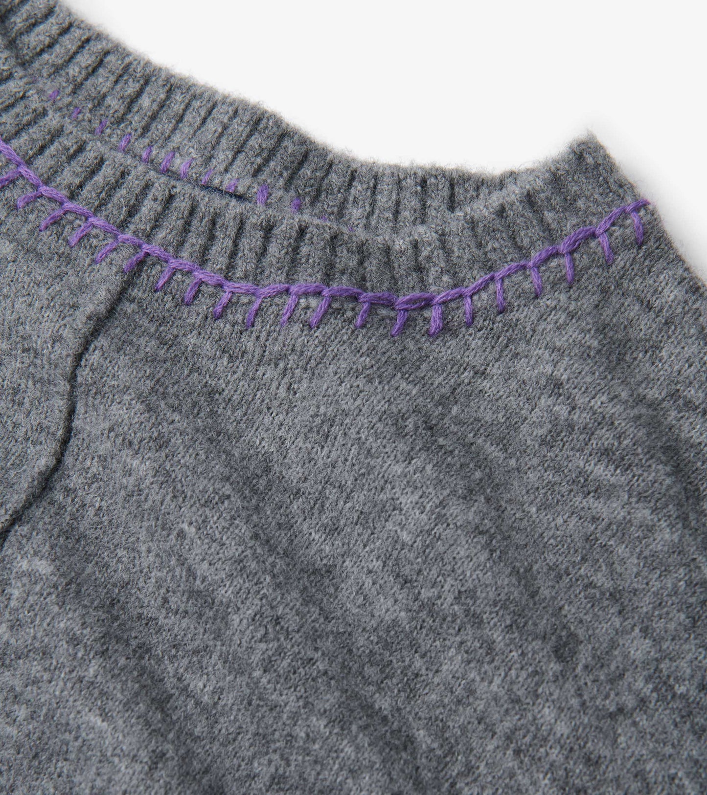 Charcoal melange sweater featuring a ribbed neckline with contrasting purple stitching.