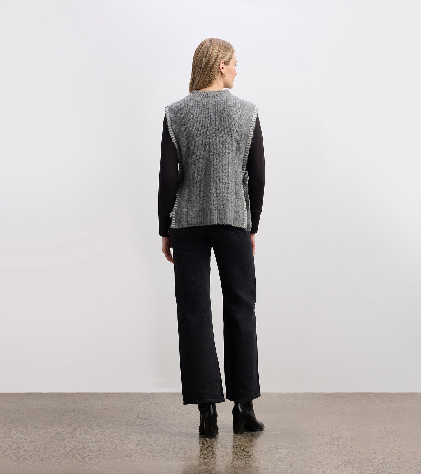 Charcoal melange side-tie sweater vest with a textured knit, featuring a relaxed fit and open sides.
