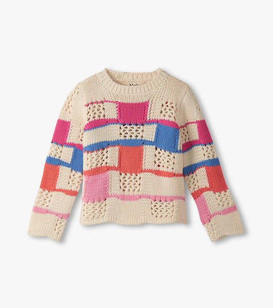 Cream sweater featuring a mix of colorful patchwork patterns and open knit details, with a round neckline and long sleeves.