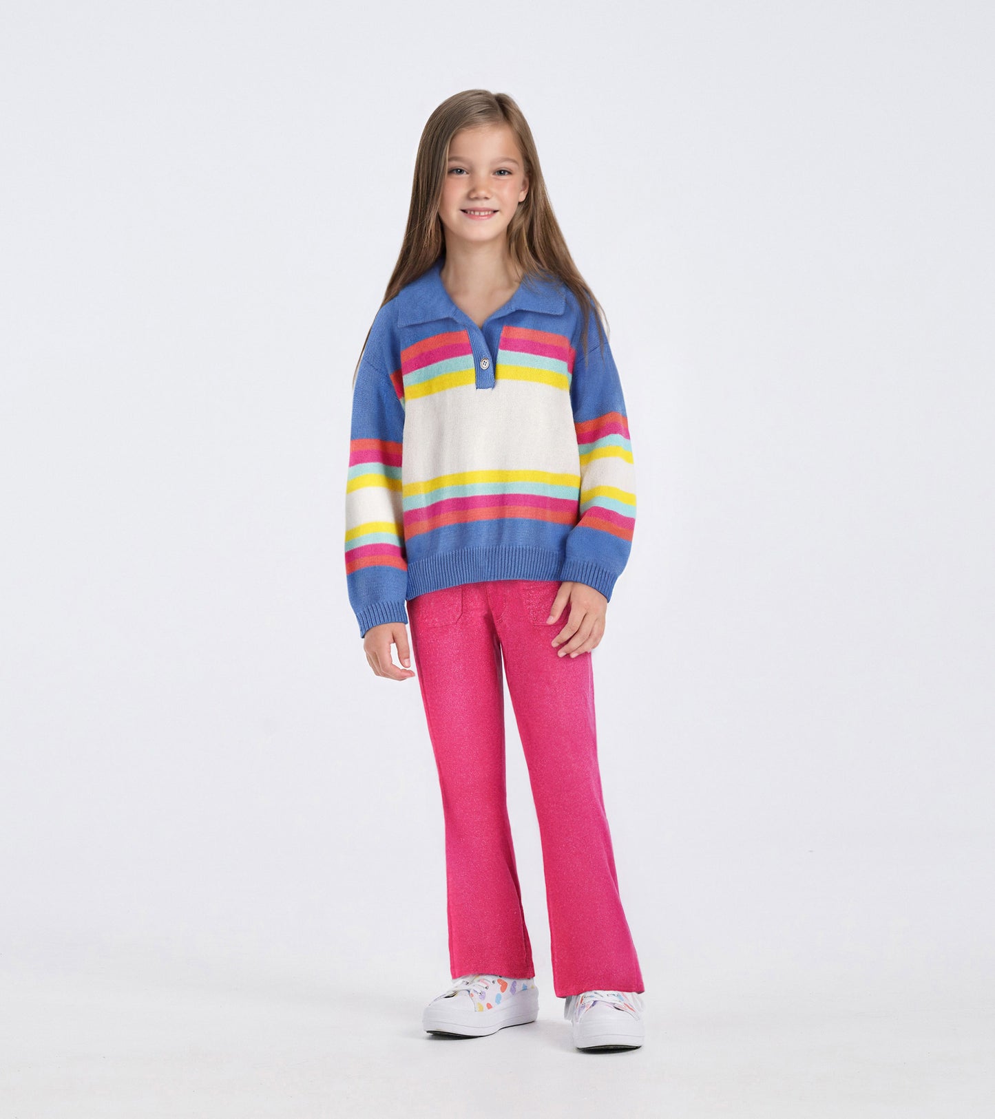Colorblock sweater featuring blue, white, and vibrant stripes, paired with pink pants, suitable for casual wear.