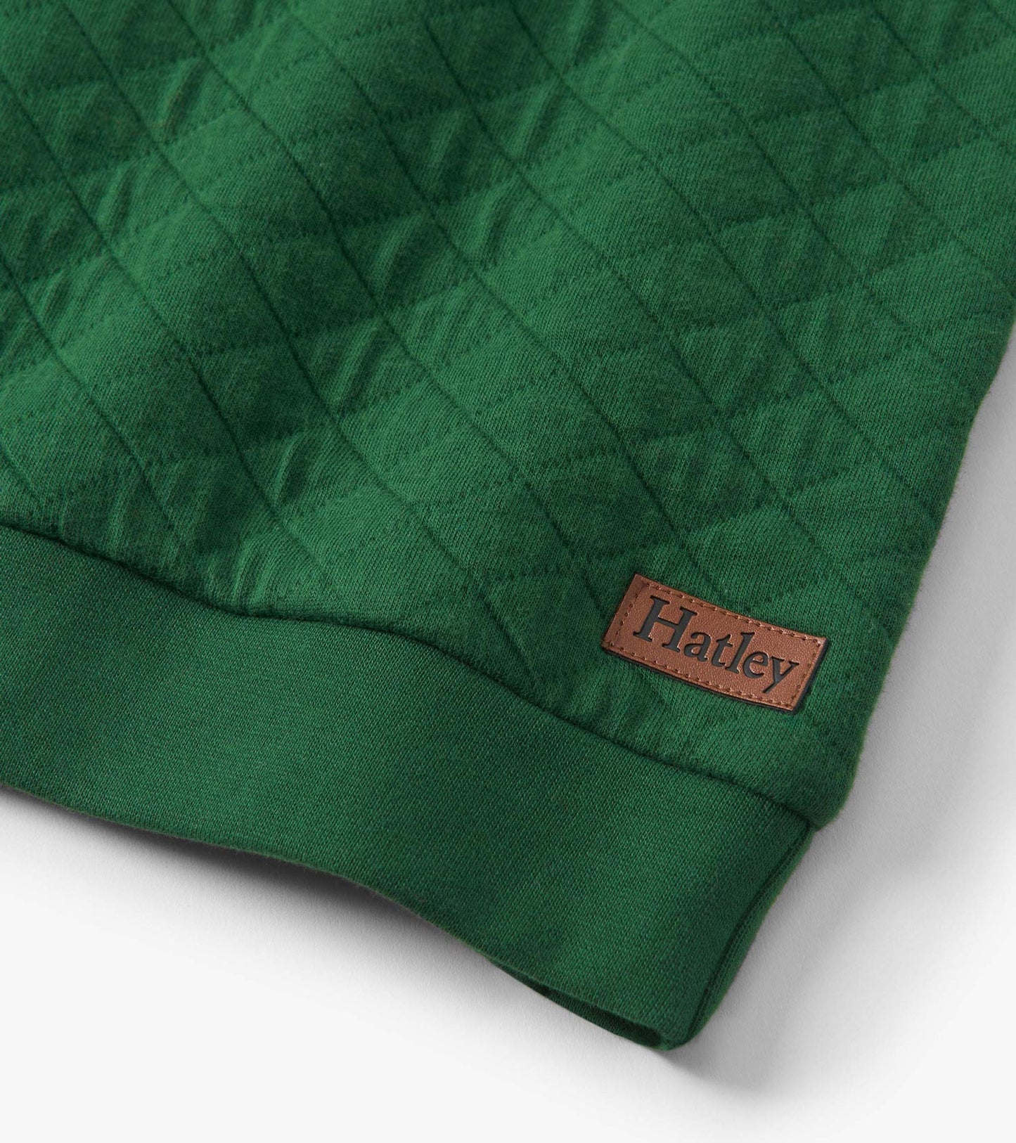 Green quilted pullover with a textured pattern and a ribbed hem, featuring a small leather tag.